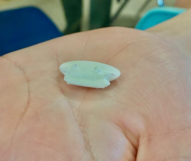 Tiny white 3D printed cow