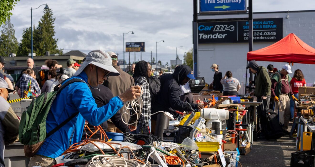 Folks looking through tools organized on tables at the Shoreline Tool Library Tool Sale.