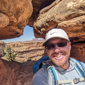Jackson Reed smiles in front of canyons and deserts.