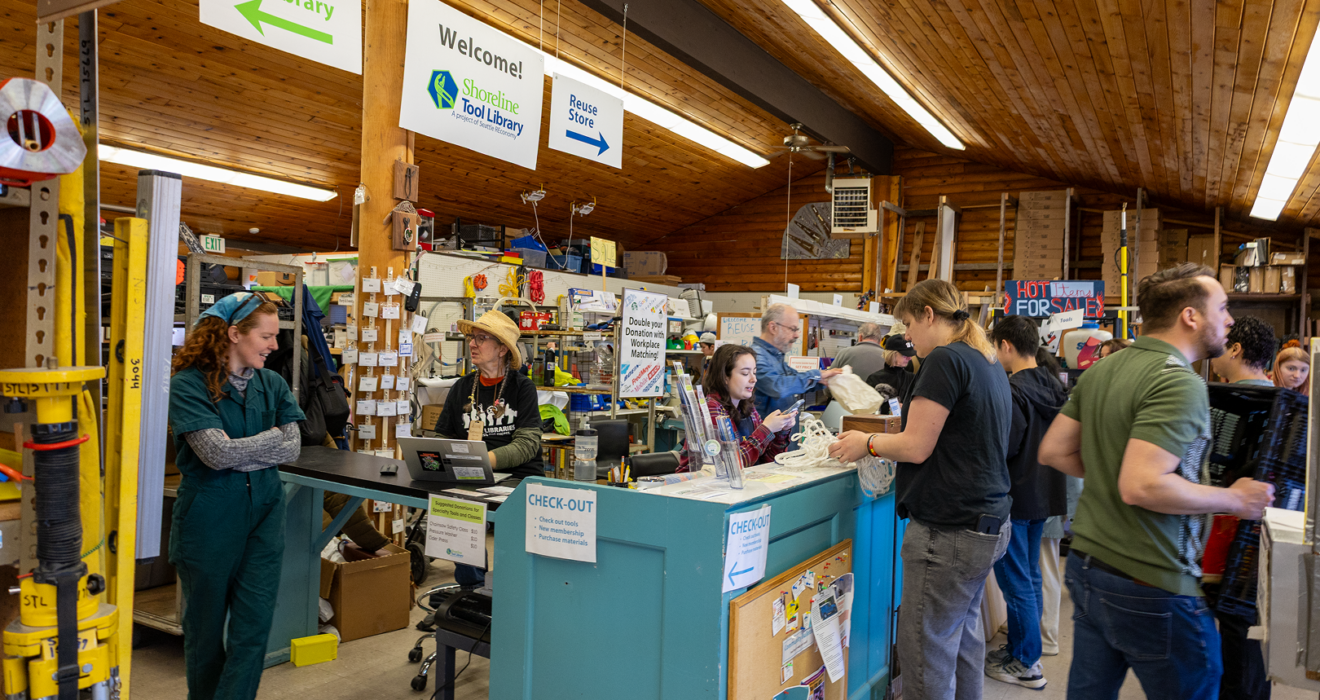 People crowd around the front area of the Shoreline Tool Library.