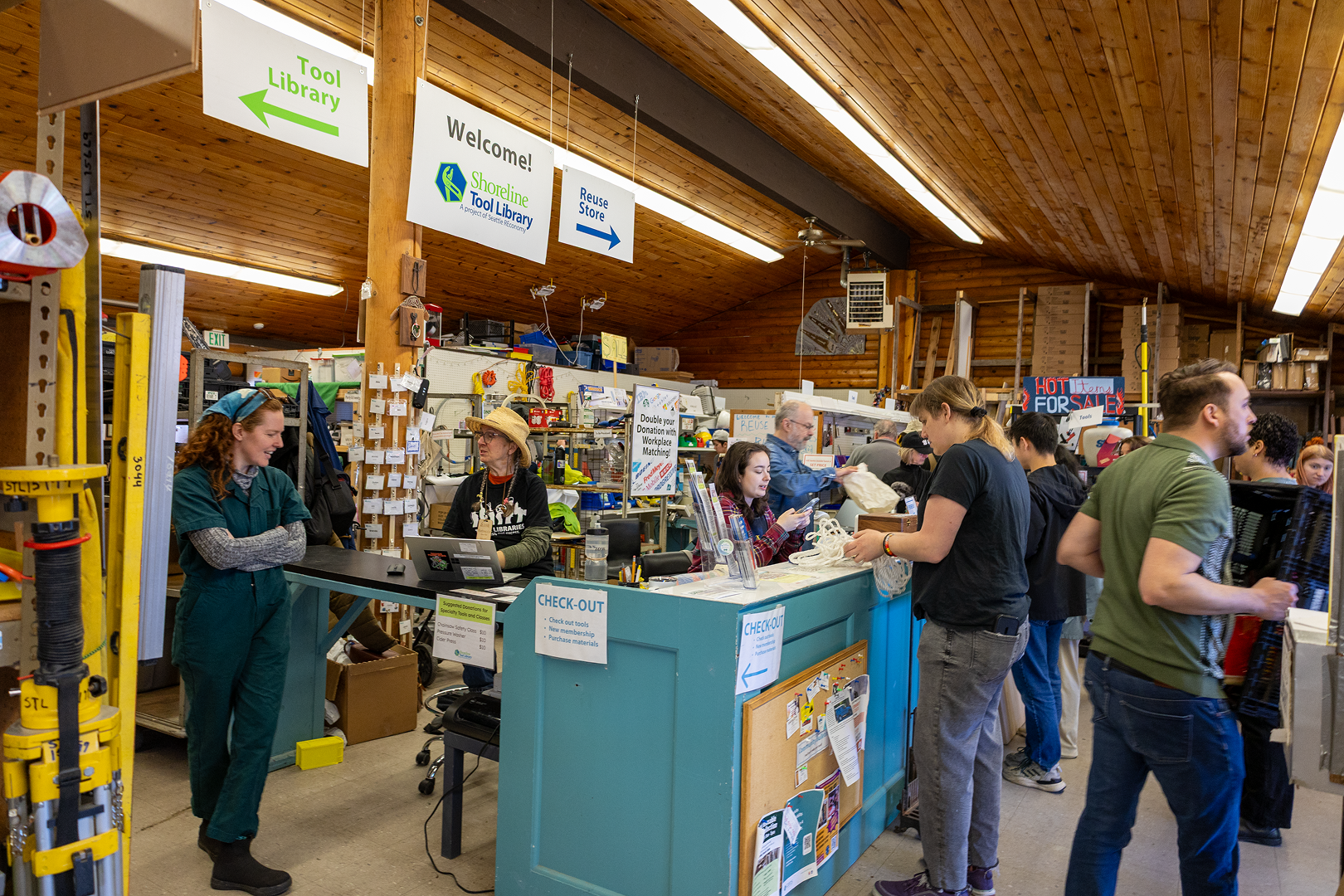 People crowd around the front area of the Shoreline Tool Library.